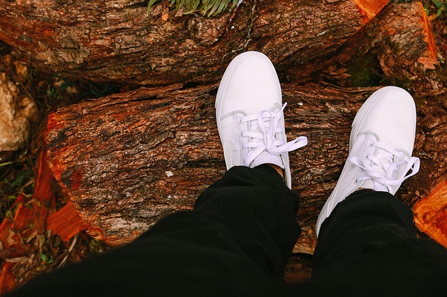 white shoes stepping on wood