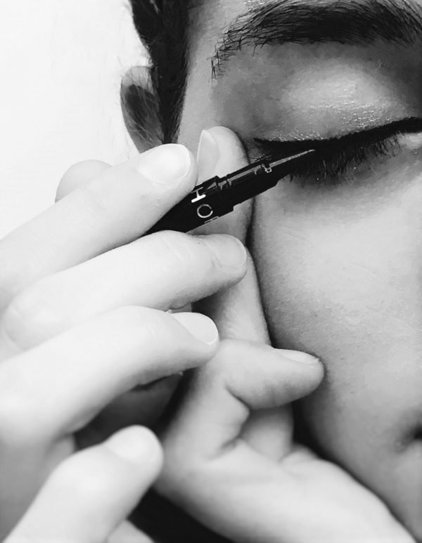 applying eye liner