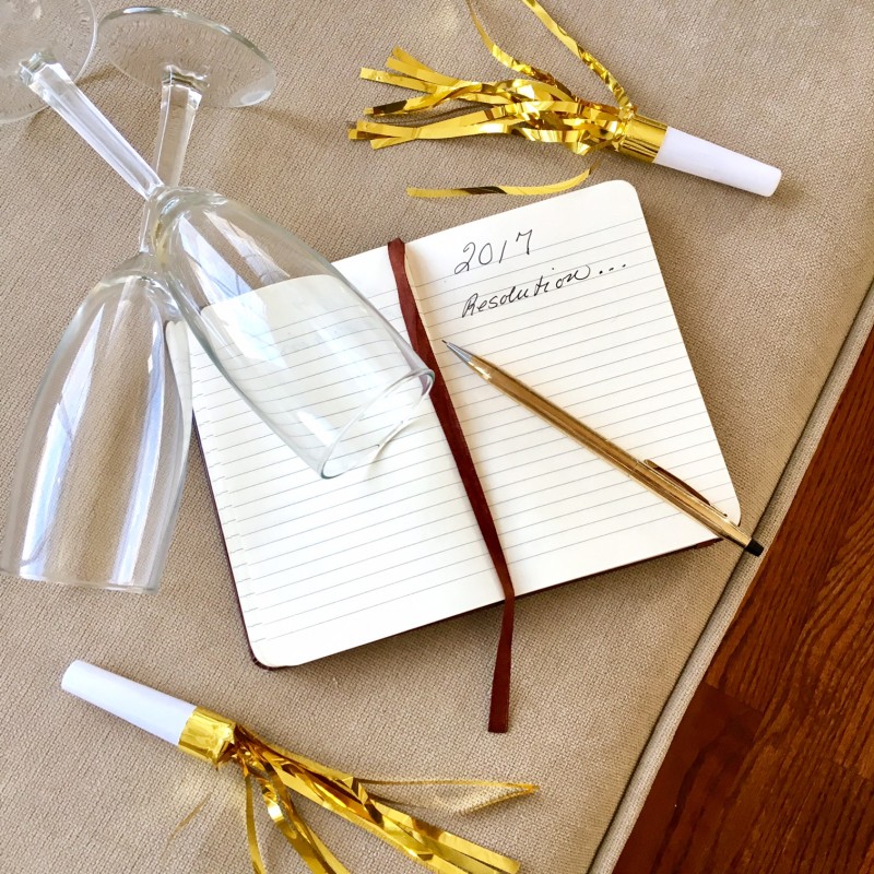 2017 new years' resolutions notebook and champagne glasses